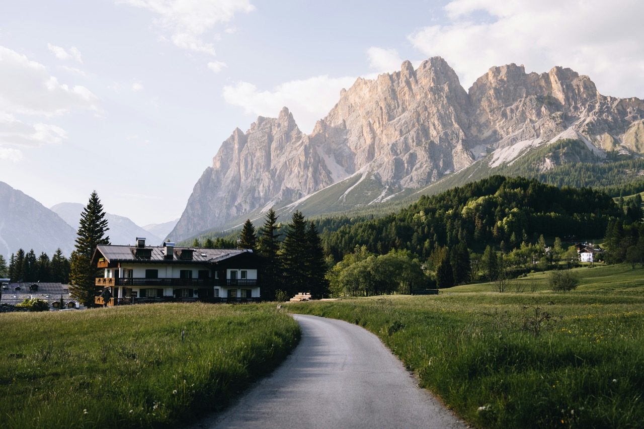 A path through mountain meadows beneath the peaks